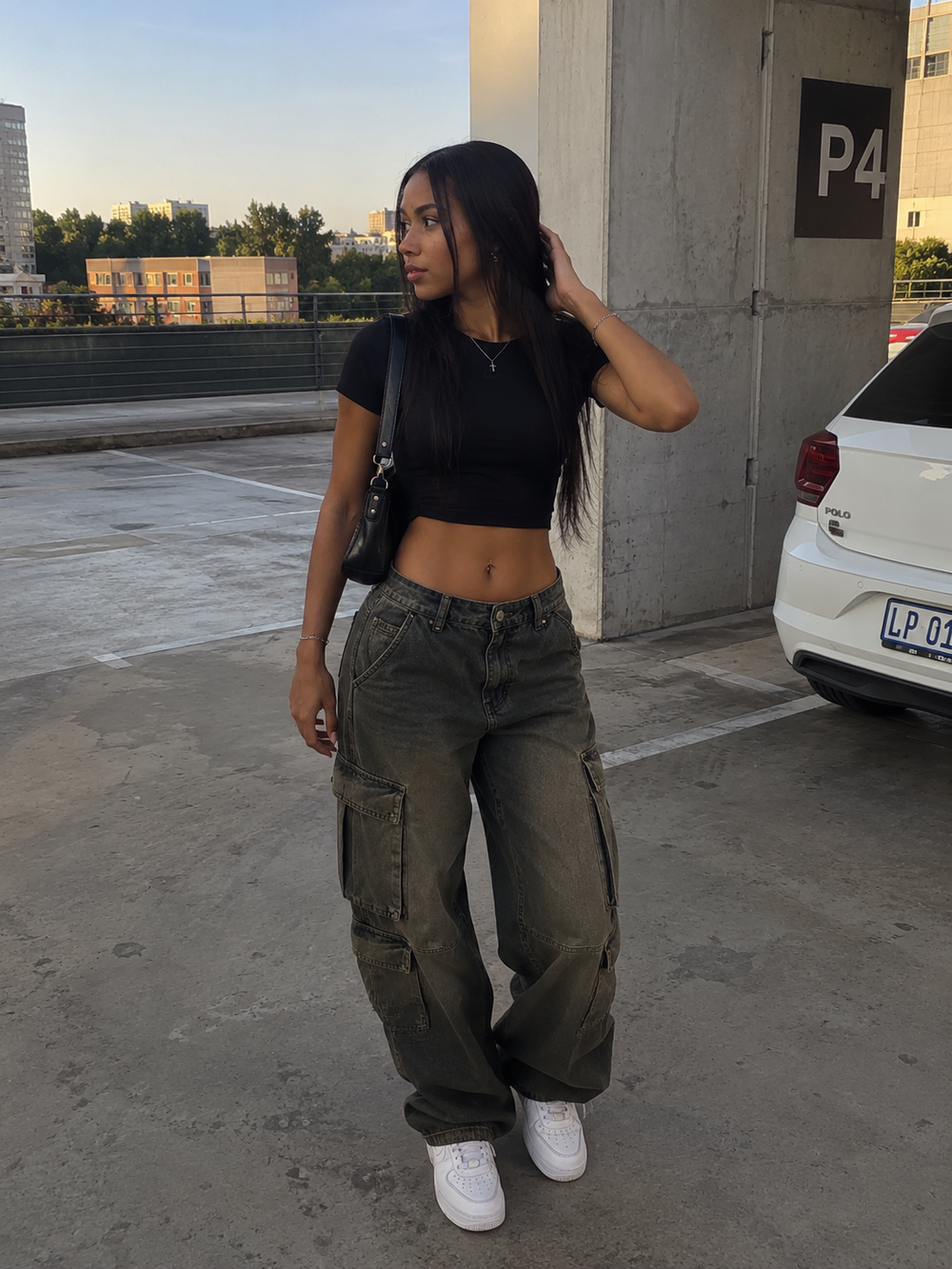 Black crop top and cargo jeans styled with white Nike Air Force 1 sneakers