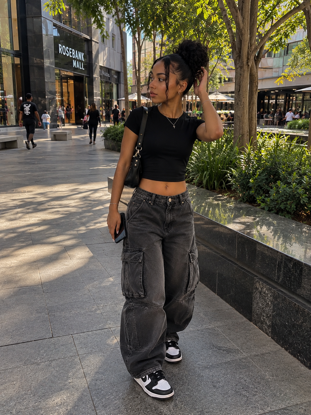 Black top and washed cargos styled with black and white Nike Dunk sneakers
